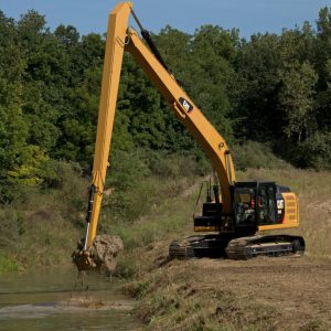 A long arm excavator dredging a river